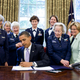 Surrounded by former WASP pilots and current and retired USAF pilots, President Barack Obama signs S.614 in the Oval Office July 1, 2009 at the White House. The bill awards the Congressional Gold Medal to Women Airforce Service Pilots. (Office of the President)